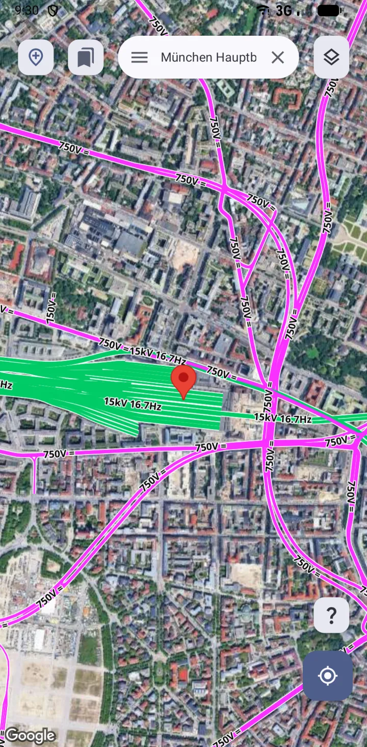 The electrification layer over satellite imagery, showing 15 kV mainline in green and the 750 V tram network in magenta